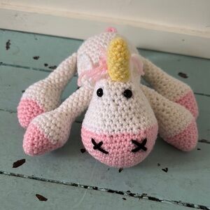 Crocheted Unicorn Hand Stitched Nose, plastic eyes Lays Flat 9” Long